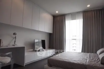 Modern bedroom with sleek furniture and natural light, featuring a cozy bed and stylish decor.