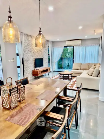Spacious modern living room with elegant decor and large windows for natural light.