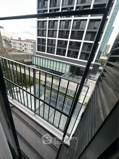 Modern apartment balcony with city view and sleek railing design.
