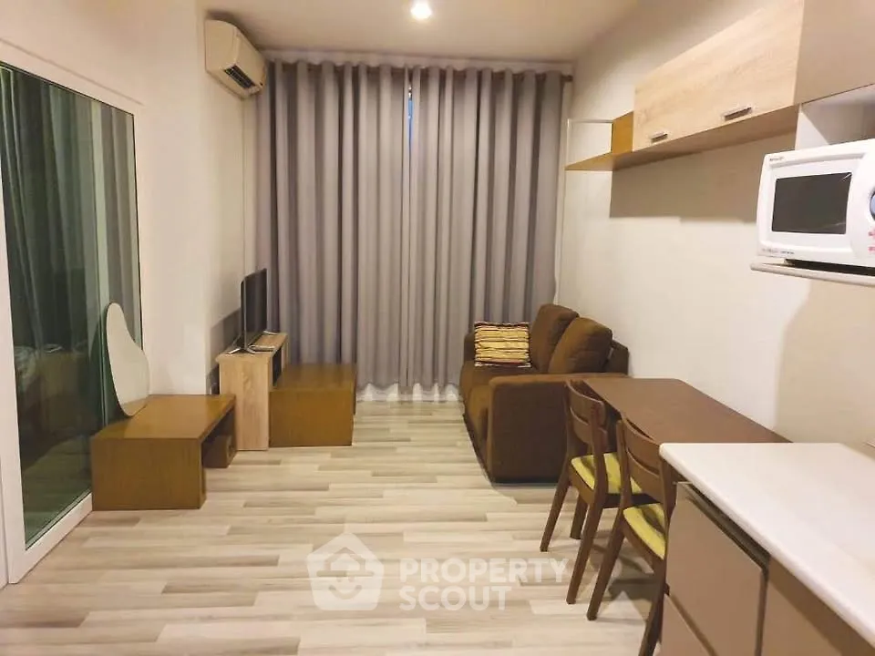 Cozy living room with modern furniture and natural light, perfect for relaxation and entertainment.