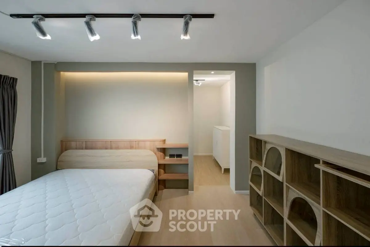 Modern minimalist bedroom with wooden furniture and ambient lighting