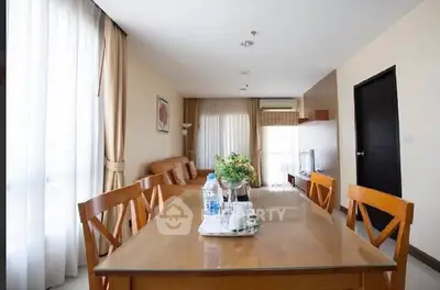 Spacious living room with elegant dining area and natural light