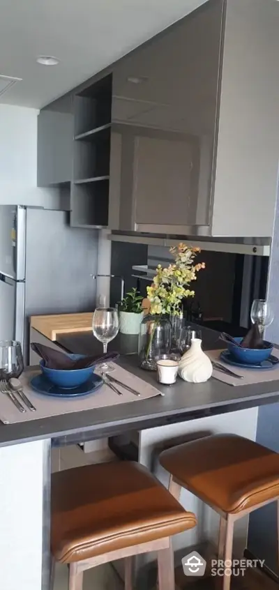 Modern kitchen with sleek cabinetry and stylish dining setup