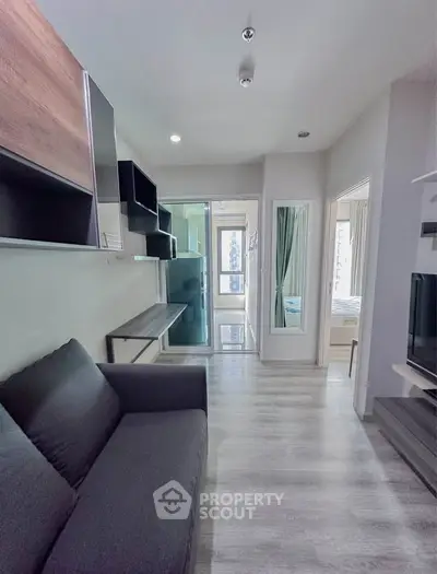 Modern apartment interior with sleek design and cozy living area, featuring a stylish sofa and open layout.
