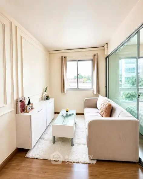 Bright and cozy living room with modern decor and large window view.