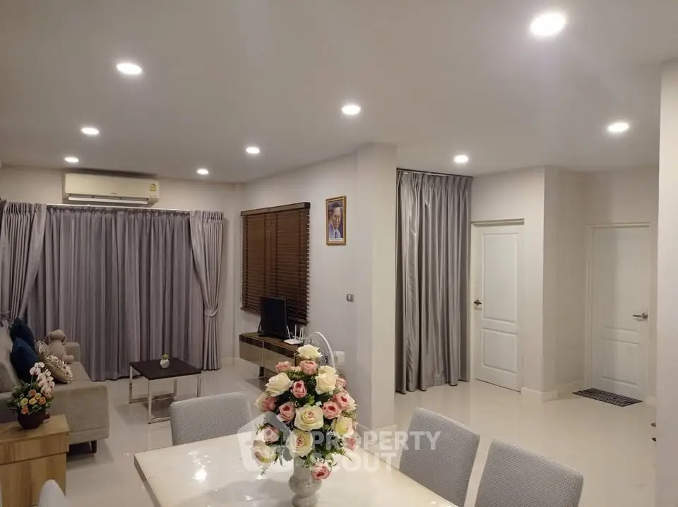 Spacious modern living room with elegant dining area and ambient lighting