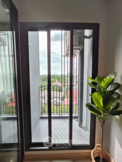 Charming balcony with stunning view and lush potted plant, perfect for relaxation.