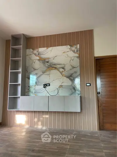 Modern living room with elegant marble accent wall and wooden flooring