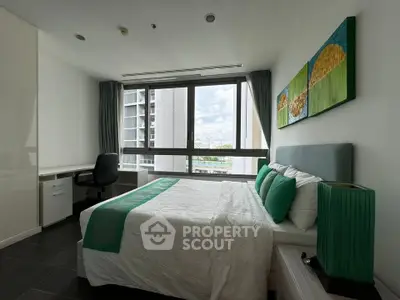 Modern bedroom with large window and stylish decor in a high-rise apartment.