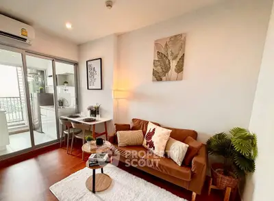 Cozy living room with stylish decor and balcony view in modern apartment