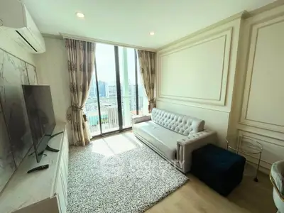 Bright and elegant living room with city view, featuring modern decor and large windows.