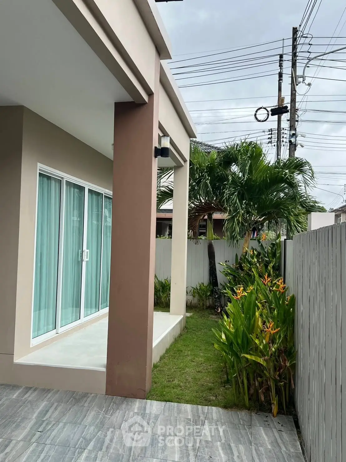 Modern exterior with sliding glass doors and lush garden