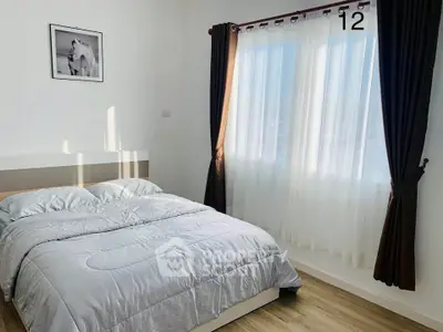 Bright and cozy bedroom with large window and elegant curtains
