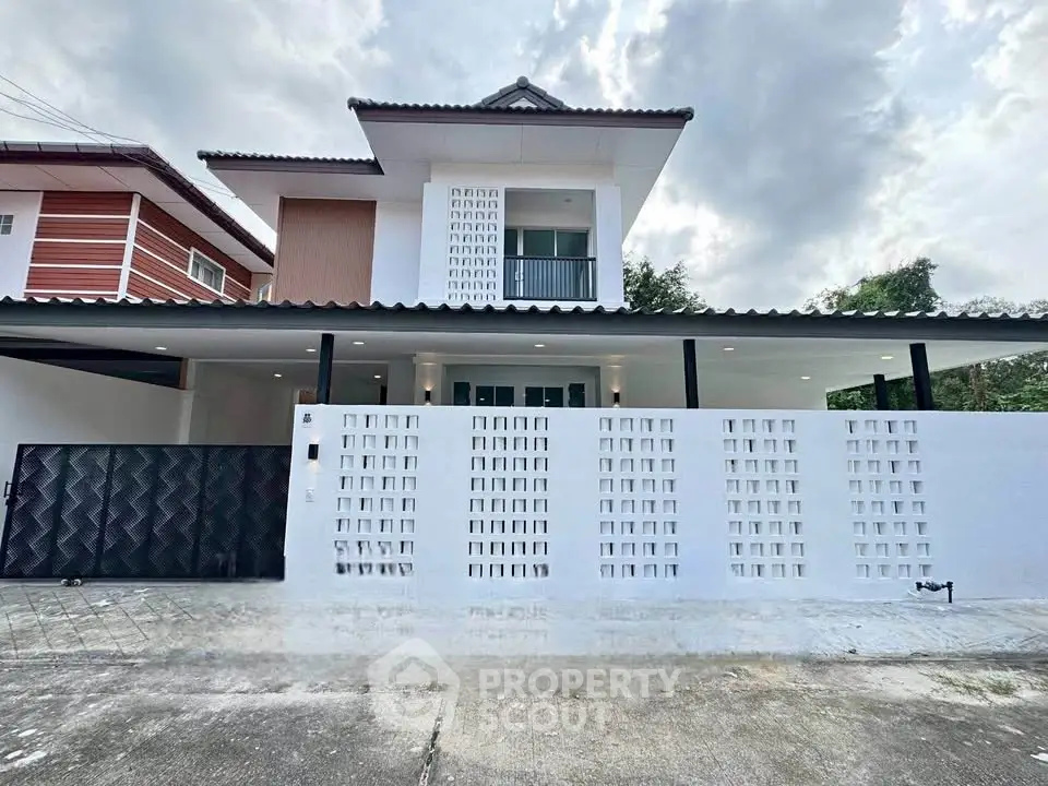 Modern two-story house with unique facade and spacious driveway in a serene neighborhood.