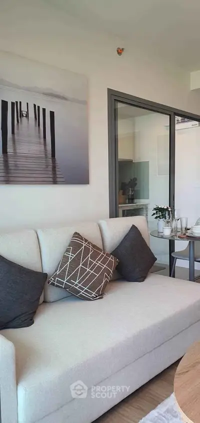 Modern living room with stylish decor and cozy seating in a contemporary apartment.