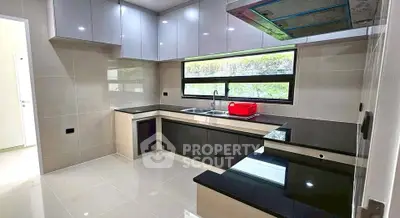 Modern kitchen with sleek black countertops and ample natural light