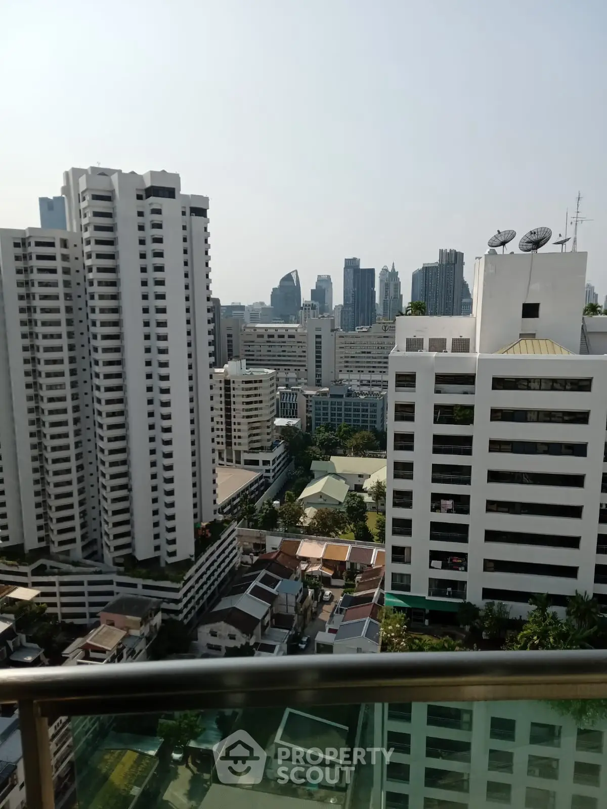 Stunning cityscape view from a high-rise balcony overlooking urban skyline.