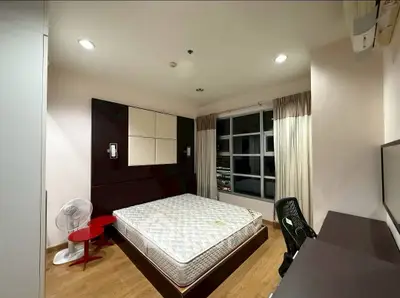Modern bedroom with large window and stylish furnishings in a cozy apartment.