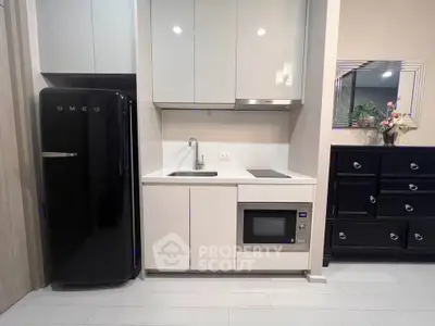 Modern compact kitchen with sleek appliances and stylish cabinetry