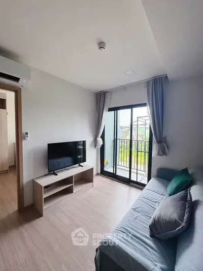 Modern living room with balcony view, featuring sleek furniture and natural light.