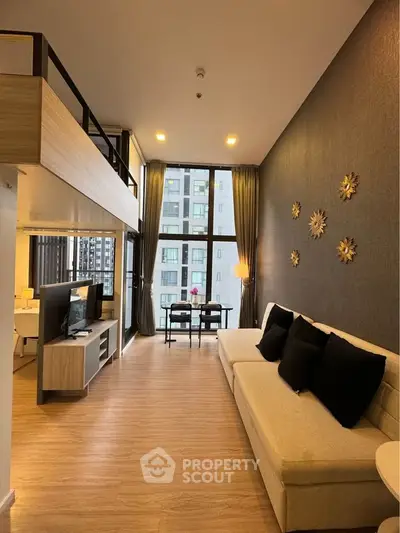 Modern loft-style living room with high ceilings and large windows offering city views.