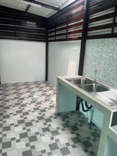 Modern kitchen with dual sink and stylish tile flooring in a contemporary home.