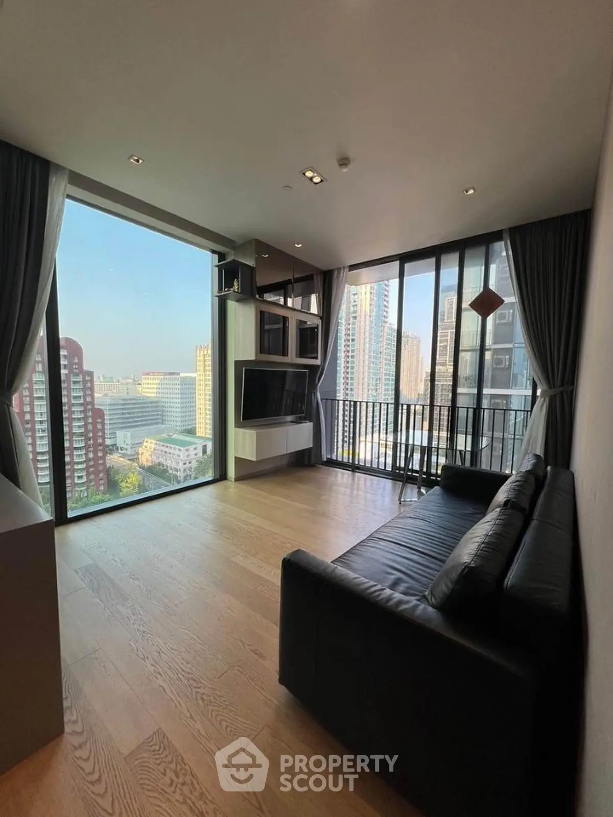 Modern living room with floor-to-ceiling windows and city view