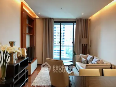 Modern living room with elegant decor and large window offering city view.