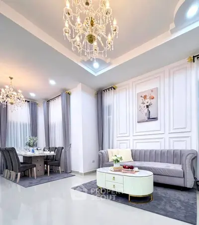 Luxurious living room with elegant chandeliers and modern dining area, perfect for sophisticated living.