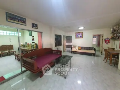 Spacious living room with traditional wooden furniture and tiled flooring