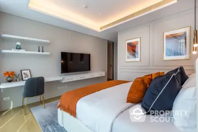 Luxurious modern bedroom with elegant decor and wall-mounted TV