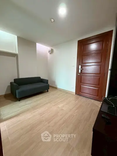 Cozy living room with wooden flooring and modern sofa, perfect for relaxation.