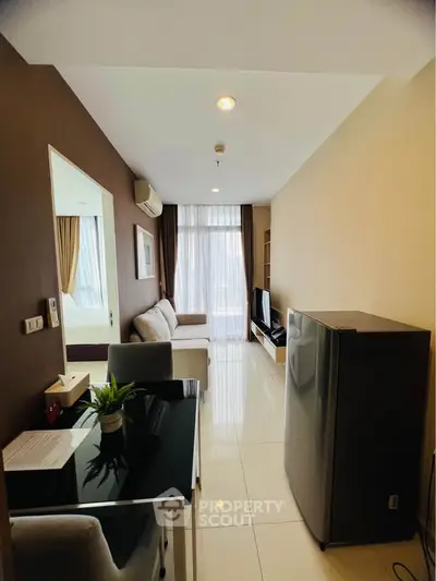 Modern living room with sleek furniture and natural light, featuring a cozy sofa and stylish decor.