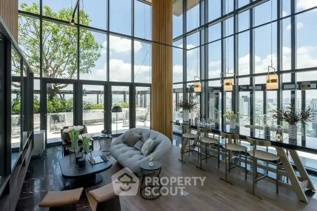 Luxurious penthouse living room with floor-to-ceiling windows and stunning city views.