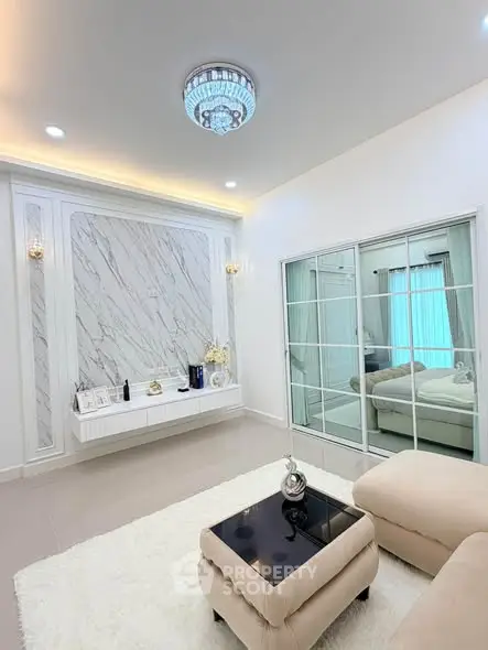Luxurious living room with elegant decor and modern furnishings, featuring a stylish marble accent wall and plush seating.