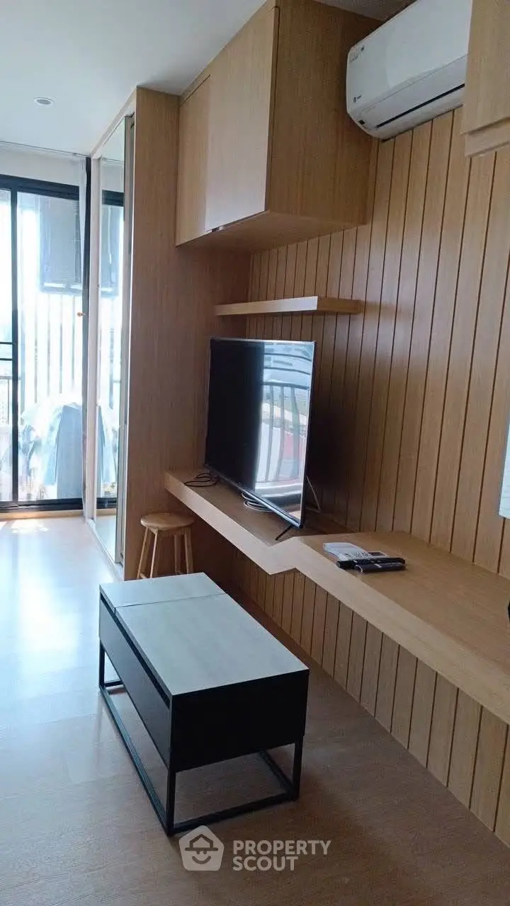 Modern living room with wooden paneling and sleek TV setup