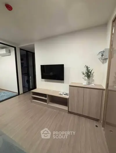 Modern living room with sleek TV setup and stylish wooden furniture