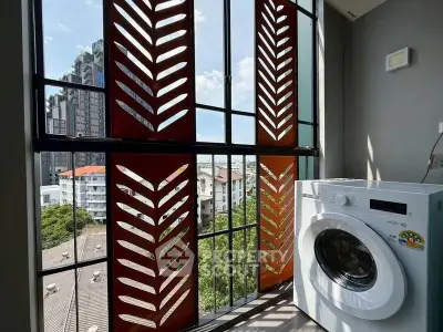 Modern apartment balcony with washing machine and city view