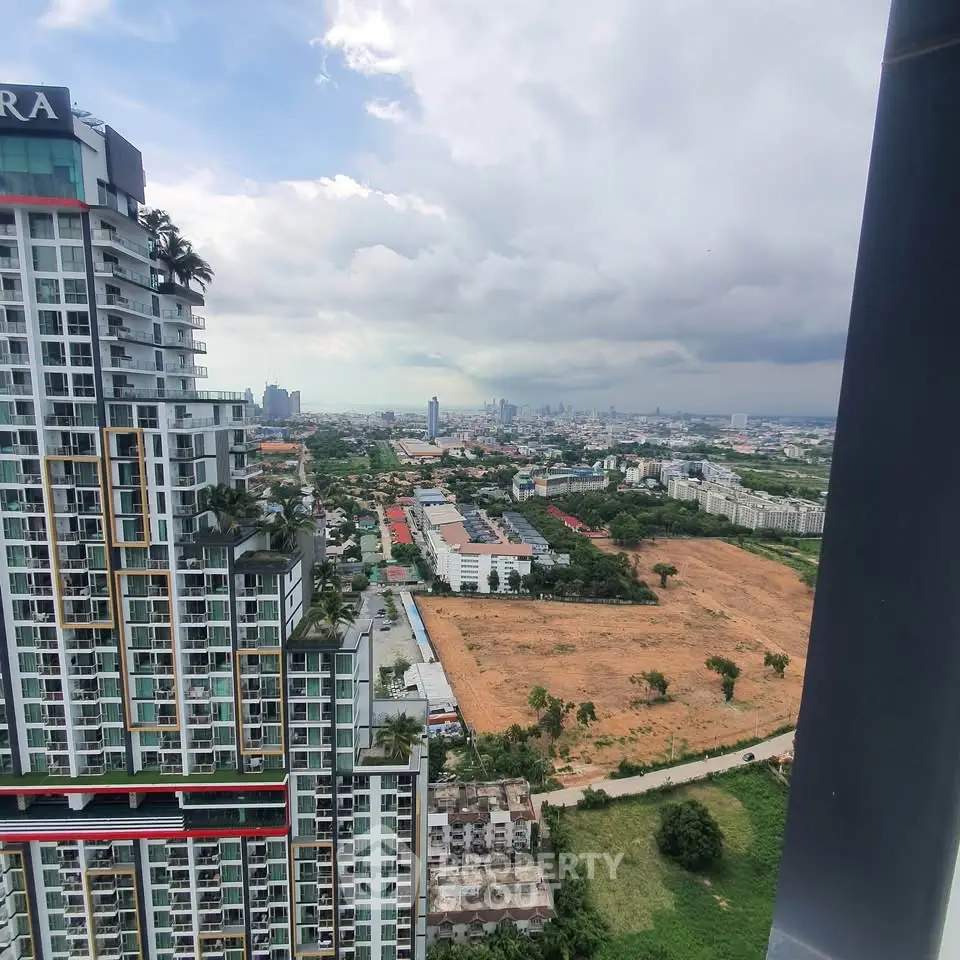 Stunning cityscape view from high-rise building with expansive skyline and lush greenery.