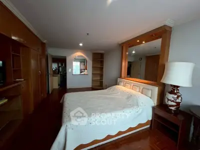 Spacious bedroom with elegant wooden furnishings and cozy ambiance
