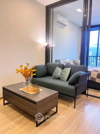 Modern living room with stylish sofa and wooden coffee table in a cozy apartment setting.