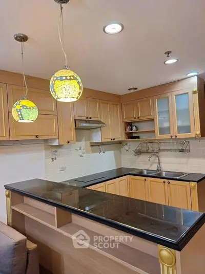 Charming kitchen with elegant wooden cabinets and stylish pendant lighting