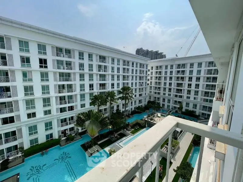 Luxurious apartment complex with stunning pool view and modern architecture.