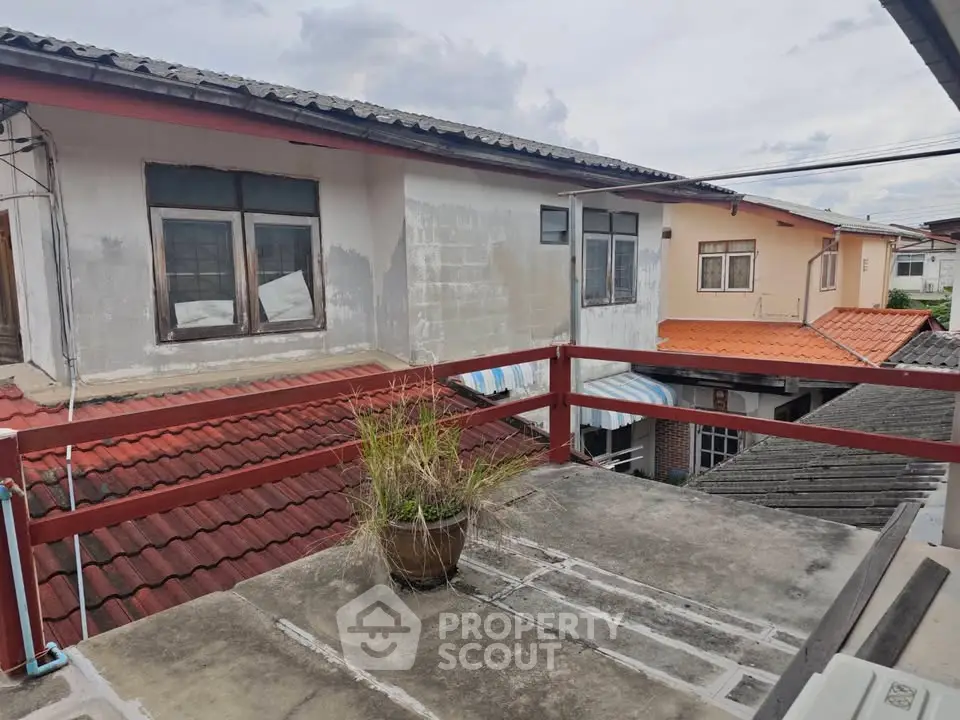 Charming rooftop view of traditional homes with red-tiled roofs and rustic charm.