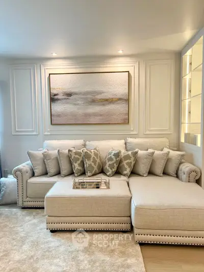 Elegant living room with plush sectional sofa and stylish wall art, perfect for modern comfort and relaxation.