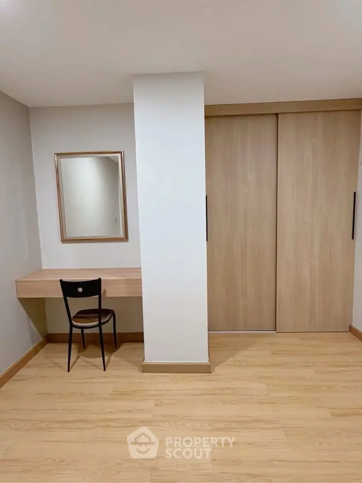 Minimalist study area with wooden desk and chair in modern apartment