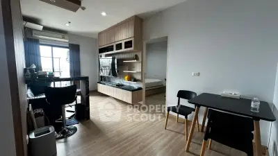 Modern studio apartment with open layout, featuring a cozy living area and stylish kitchen.