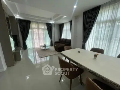 Spacious modern living room with elegant decor and ample natural light.
