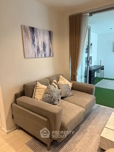 Cozy living room with modern sofa and abstract art, perfect for relaxation.