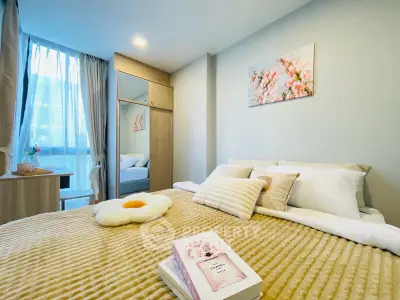Cozy bedroom with elegant decor and natural light, featuring a plush bed and stylish furnishings.